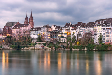 Fototapeta na wymiar Scenic view of Rhine waterfront with Basel Minster in the background, Switzerland