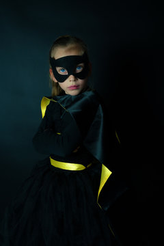 Portrait Of Girl Wearing Costume Standing Against Black Background