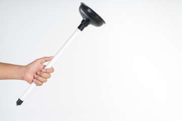 Hand holding toilet black rubber plunger or toilet suction cup
