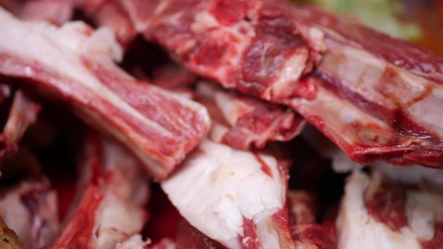 Chief-cooker take raw meat lamb in counter of store. Fresh cut mutton
