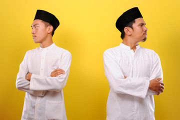 Image of two Young Asian Muslim men hating each other, not greeting each other when Ramadan....