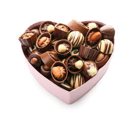 Heart-shaped box with delicious candies on white background