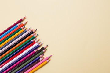 Colored pencils series on a light yellow uniform paper background.