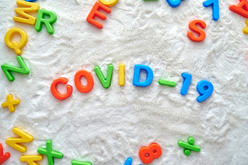 Covid-19 inscription made of plastic letters in the children's room. 