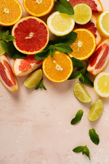Orange, lemon, grapefruit, mandarin and lime on trendy pink stone or concrete table background. Citrus fruits. Top view, flat lay