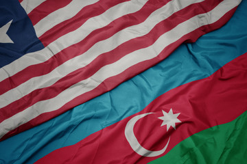 waving colorful flag of azerbaijan and national flag of liberia.
