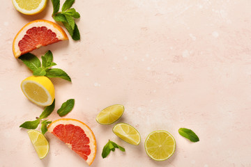 Orange, lemon, grapefruit, mandarin and lime on trendy pink stone or concrete table background. Citrus fruits. Top view, flat lay