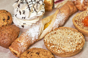 A variety of fresh pastries. Closeup on a light background
