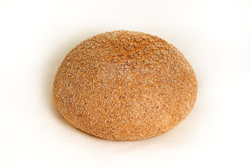 Grey round bread made of rye flour. Closeup on a light background