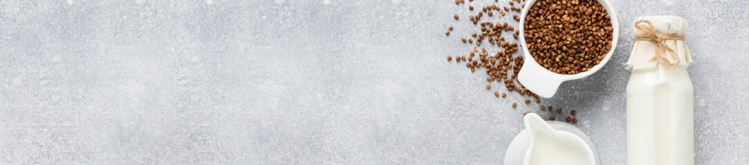 Homemade diet vegetable milk made from buckwheat on a gray background. Diet healthy concept. Copy space and Banner.Top view.