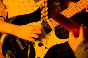 Life style image of close up young male guitarist hand, playing electric guitar