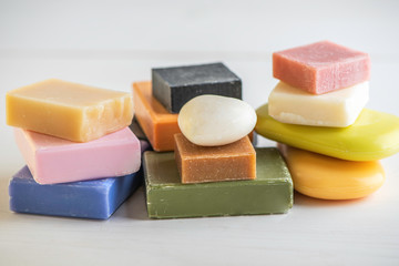 selection of colorful  natural rose olive orange carbon coal charcoal black soap bar block isolated on white background 