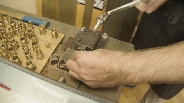 Jeweller creating a gold ring with a Bending machine