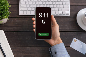 Worker holding smart phone with emergency number