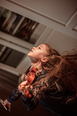 Cute girl plays the violin, low key, quarantine class idea. Music concept