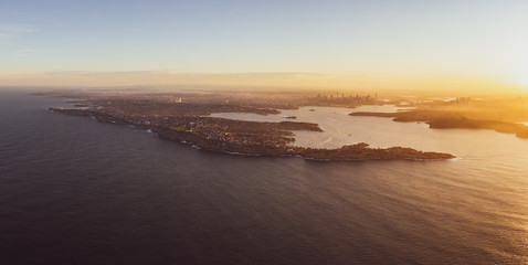 Fototapeta na wymiar XXL panoramic sunset aerial drone view of South Head, a headland to the north of the suburb of Watsons Bay in Sydney, New South Wales, Australia. Sydney Harbour, CBD & Harbour Bridge in the background