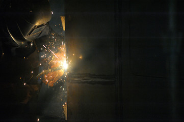 Worker With Protective Mask Welding