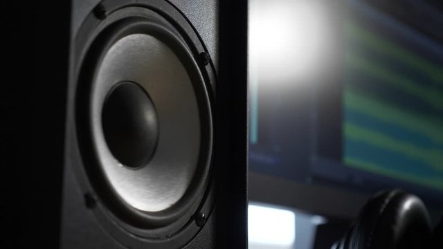 Slow motion Speaker Vibrating Playing Loud Music Beat Near Computer Monitor at Home Recording Studio