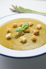 Cream of zucchini  with croutons, oil and fresh vegetables
