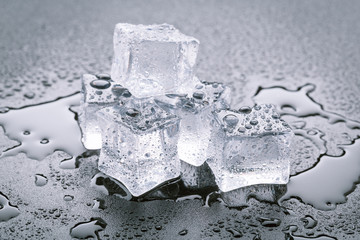 Pyramid of beautiful thawed ice cubes with drops of water