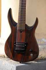 Fototapeta premium Seven-string electric guitar made of dark wood. Background for music and creativity.