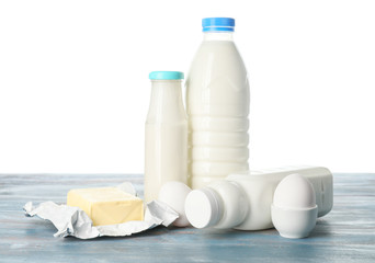 Different dairy products on table against white background