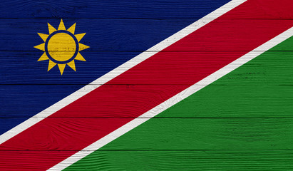 Namibia flag on a wooden texture. Wood texture, planks Wooden texture background flag. Flag painted with paints on wood