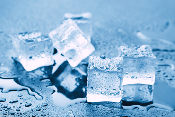 Pyramid of beautiful thawed ice cubes with drops of water