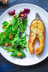 pink salmon steak fried and salad,
grilled seafood, pescatarian Menu concept food background keto or paleo diet. top view. copy space for text