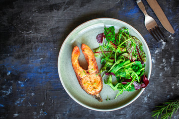 pink salmon steak fried and salad,
grilled seafood, pescatarian Menu concept food background keto or paleo diet. top view. copy space for text