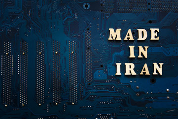 Made in Iran. Inscription on a blue electronic printed circuit board. Iranian electronics industry...