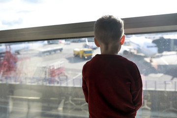 Child waiting for flight at airport