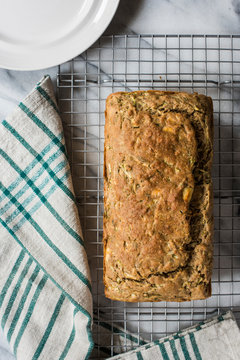 Fresh baked Savory Zucchini and Olive Loaf with Feta Cheese and Herbs sitting on cooling rack