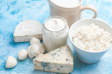 Different dairy products on color background