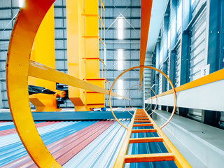 Overhead crane and fixed ladder inside factory building, industrial background