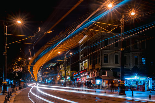 Night streets of Istanbul. Photo taken at a long exposure. Streets of the old city and lights of the evening city. A tram on the tracks at night.