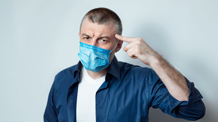 Fototapeta na wymiar Mature Man Wearing Medical Mask Touching Forehead, Gray Background, Panorama