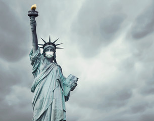 Fototapeta premium Stock photo of the New York's Statue of Liberty with a mask caused by the coronavirus and copy space