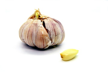 whole garlic and a slice on a white background
