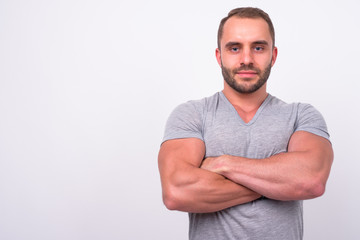 Portrait of muscular bearded man with arms crossed