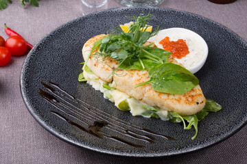 White fish cutlet served with caviar