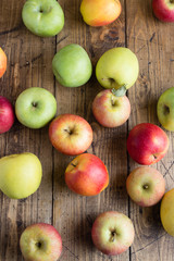 Ripe red apples on a wooden table. Top view with space for text.