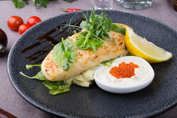 White fish cutlet served with caviar