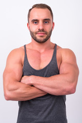 Portrait of muscular bearded man with arms crossed