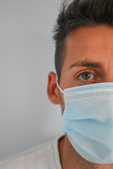 Face of a man with surgical mask in quarantine in his own home, coronavirus