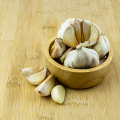 Garlic isolated on wood background