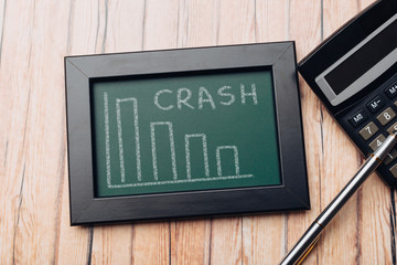 charts of economics and stock markets on a chalk board. financial crisis concept.