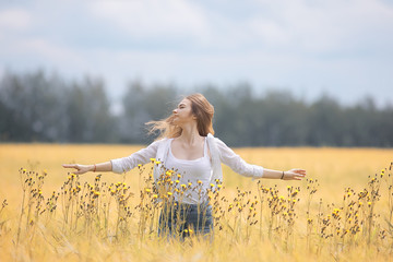 happy girl in autumn field with spikelets landscape / adult young girl portrait, summer look, nature
