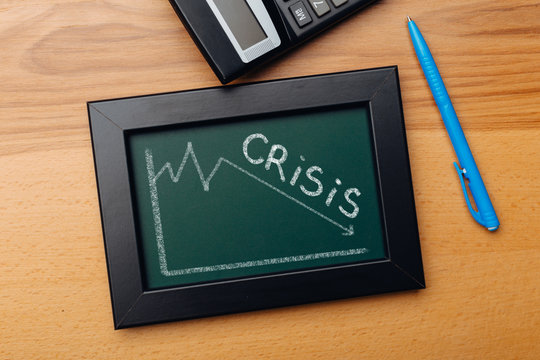 charts of economics and stock markets on a chalk board. financial crisis concept.