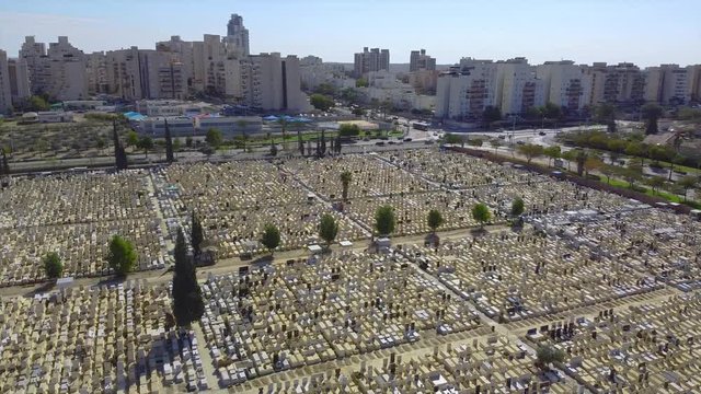 Slow panoramic from the tombs on old cemetery to buildings in Beer Sheba city